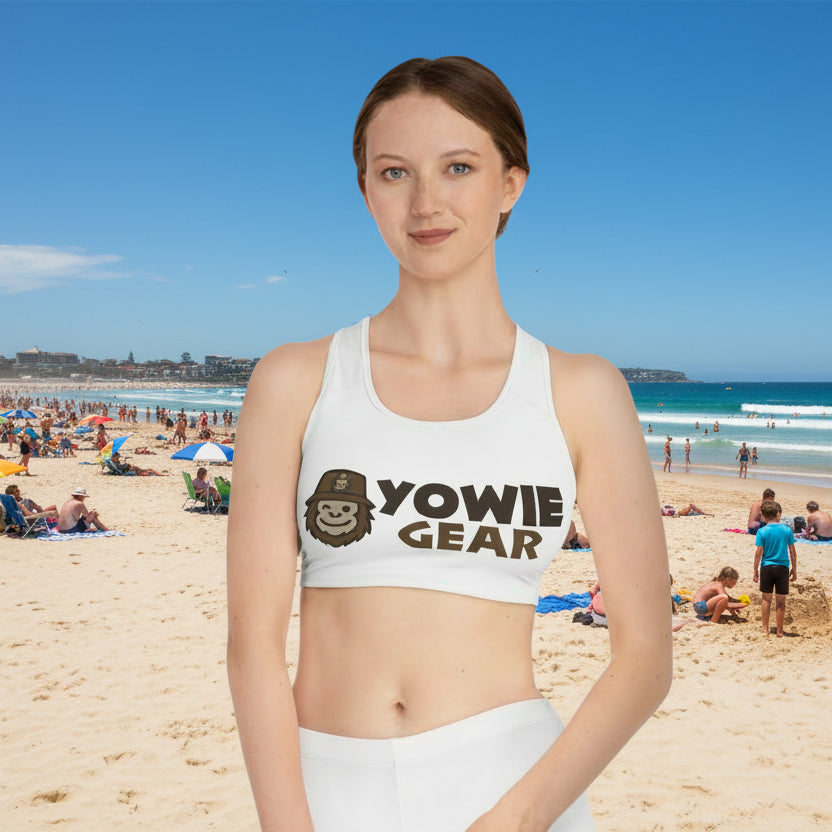 Woman wearing a white sports bra with 'Yowie Gear' logo on a white background